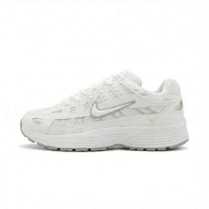 ATLAS. — A lace-up sneaker with layered panels and a raised sole.