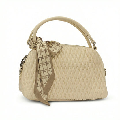 Dune — A quilted top-handle bag with a tied scarf detail.