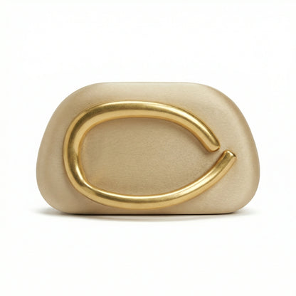 Moonstone — A compact clutch with a rounded shape and oversized ring detail.
