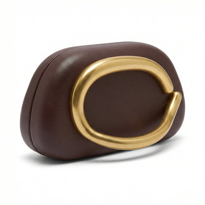 Moonstone — A compact clutch with a rounded shape and oversized ring detail.