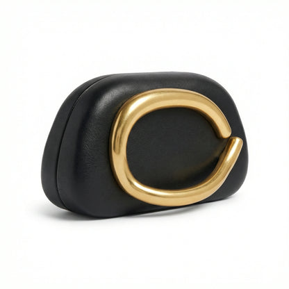 Moonstone — A compact clutch with a rounded shape and oversized ring detail.