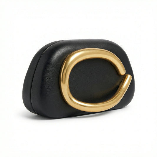TKN Moonstone cream clutch bag featuring a large organic gold metal ring detail and soft rounded shape