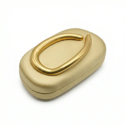 Moonstone — A compact clutch with a rounded shape and oversized ring detail.