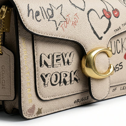 Graphite — A structured shoulder bag with a flap, graphic print and front clasp detail.