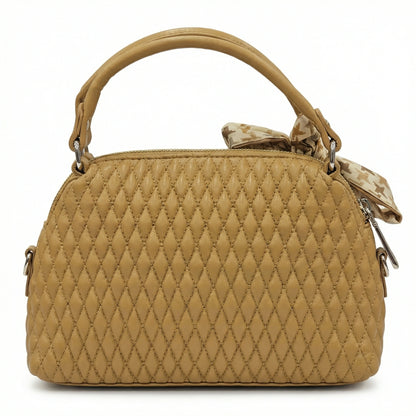 Dune — A quilted top-handle bag with a tied scarf detail.