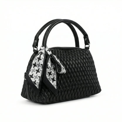 Dune — A quilted top-handle bag with a tied scarf detail.
