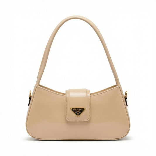 TKN Jet black patent leather shoulder bag featuring curved silhouette and triangular gold logo.