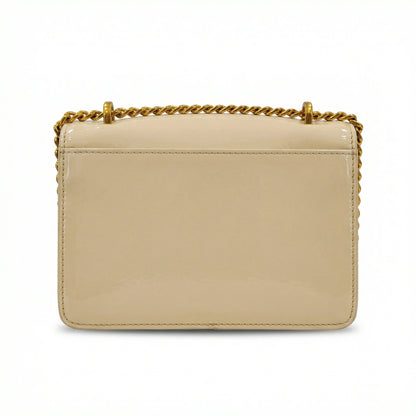 Quartz — A compact flap-style crossbody bag with a chain strap and metal accent.