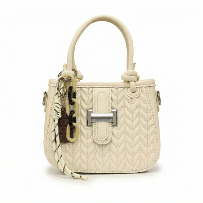 Basalt — A compact crossbody bag with a top handle and wide webbing strap.