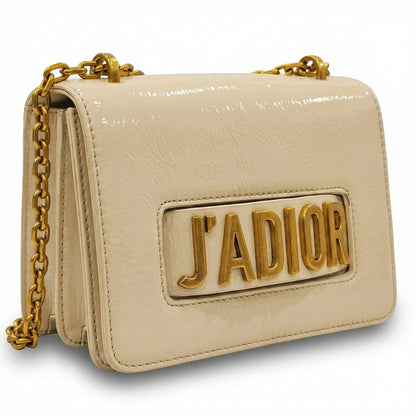Quartz — A compact flap-style crossbody bag with a chain strap and metal accent.