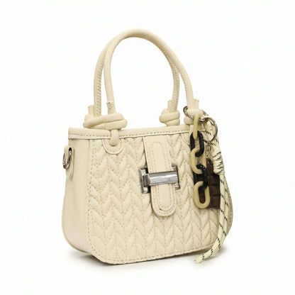Basalt — A compact crossbody bag with a top handle and wide webbing strap.