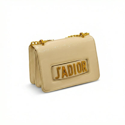 Quartz — A compact flap-style crossbody bag with a chain strap and metal accent.