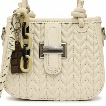 Basalt — A compact crossbody bag with a top handle and wide webbing strap.