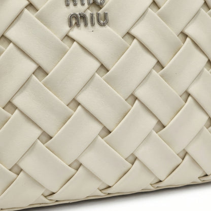 Slate — A top-handle bag with a quilted texture and metal details.