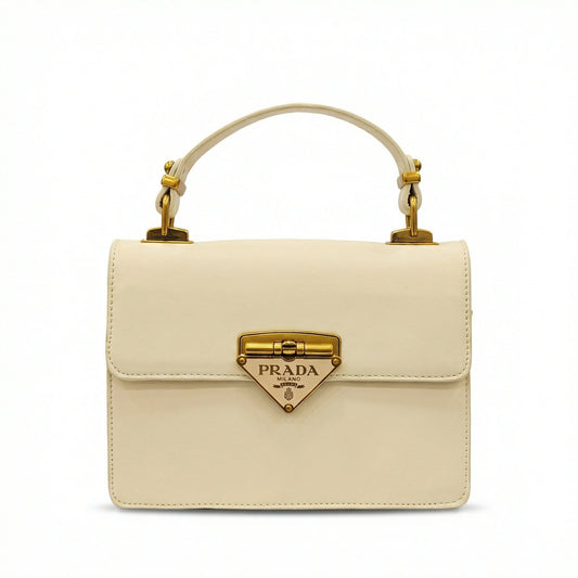 TKN Pearl structured top handle bag featuring triangular gold logo and detachable strap