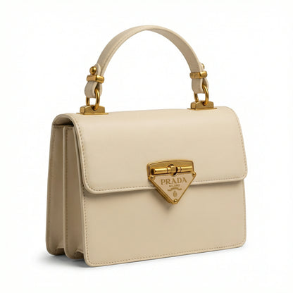 Pearl — A structured top-handle bag with a flap and front metal detail.