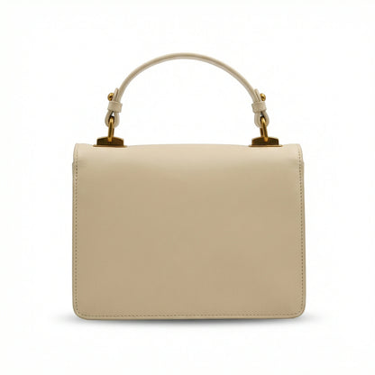 Pearl — A structured top-handle bag with a flap and front metal detail.