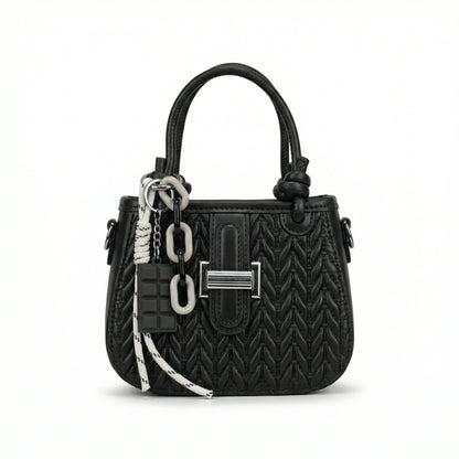 Basalt — A compact crossbody bag with a top handle and wide webbing strap.