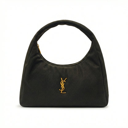 Eclipse — A curved shoulder bag with a textured finish and small metal detail.