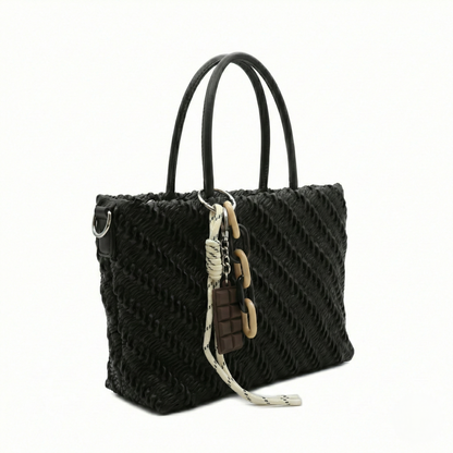 Mousse — A top-handle bag with a gathered-look finish and chain accent.