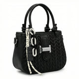 Basalt — A compact crossbody bag with a top handle and wide webbing strap.
