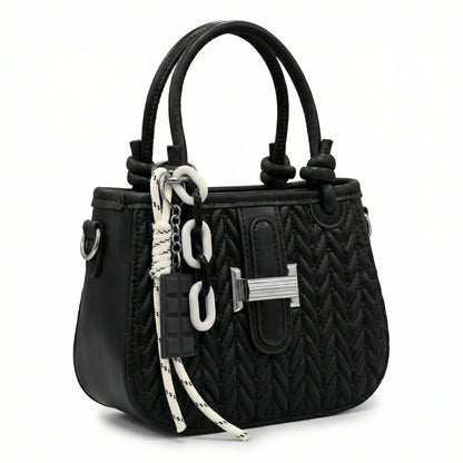Basalt — A compact crossbody bag with a top handle and wide webbing strap.