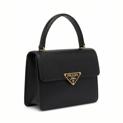 Pearl — A structured top-handle bag with a flap and front metal detail.