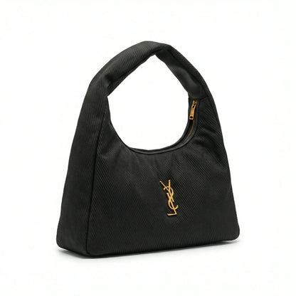 Eclipse — A curved shoulder bag with a textured finish and small metal detail.