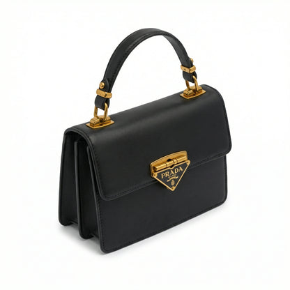 Pearl — A structured top-handle bag with a flap and front metal detail.