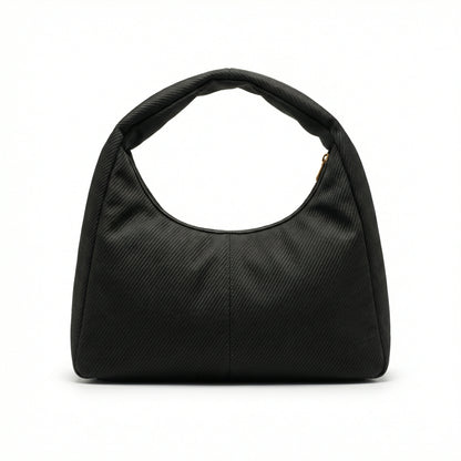 Eclipse — A curved shoulder bag with a textured finish and small metal detail.