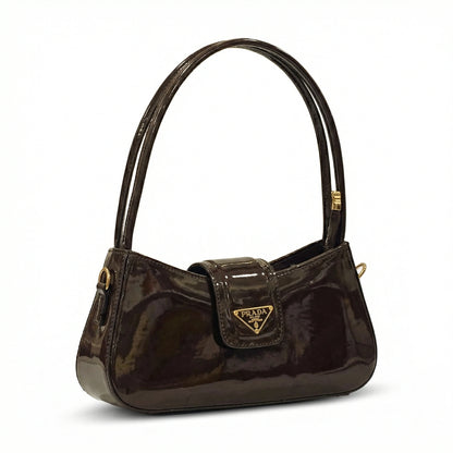 Jet — A curved shoulder bag with a smooth finish and small metal detail.