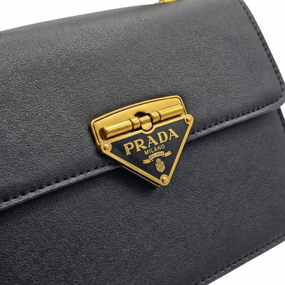 Pearl — A structured top-handle bag with a flap and front metal detail.