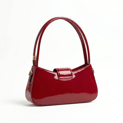Jet — A curved shoulder bag with a smooth finish and small metal detail.