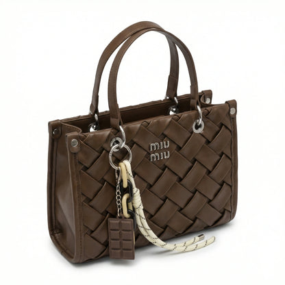 Slate — A top-handle bag with a quilted texture and metal details.
