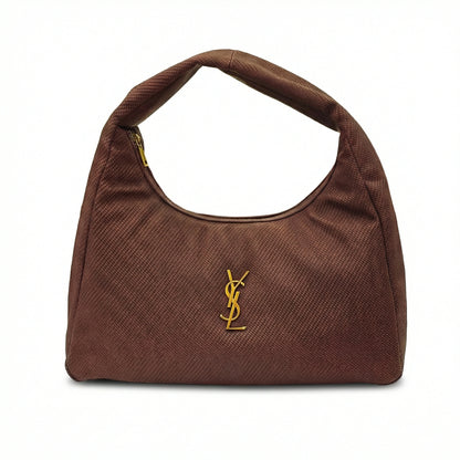 Eclipse — A curved shoulder bag with a textured finish and small metal detail.