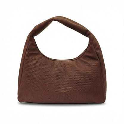 Eclipse — A curved shoulder bag with a textured finish and small metal detail.
