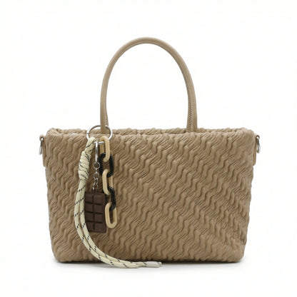Mousse — A top-handle bag with a gathered-look finish and chain accent.