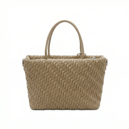 Mousse — A top-handle bag with a gathered-look finish and chain accent.