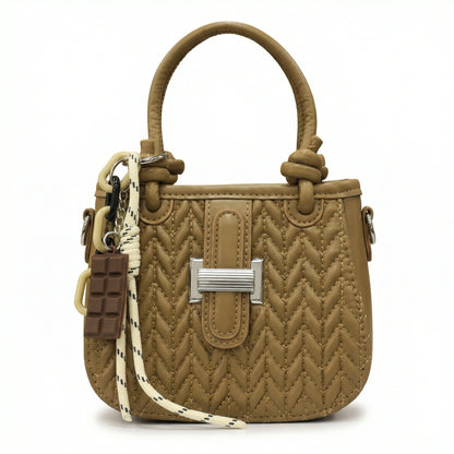 Basalt — A compact crossbody bag with a top handle and wide webbing strap.