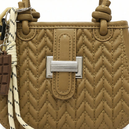 Basalt — A compact crossbody bag with a top handle and wide webbing strap.