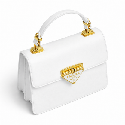 Pearl — A structured top-handle bag with a flap and front metal detail.