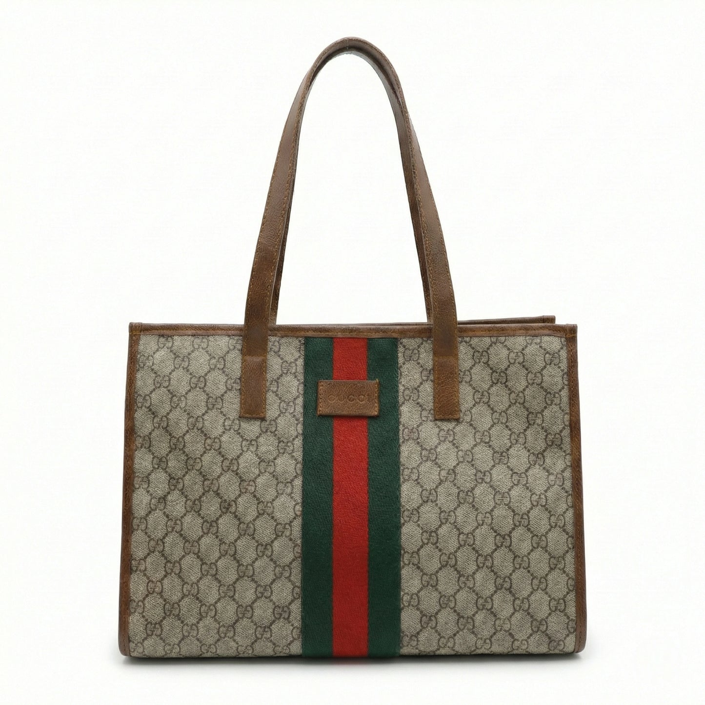 TKN Heritage tote bag featuring a signature brown monogram canvas, central green and red webbing stripe, and chocolate leather handles