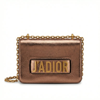 Quartz — A compact flap-style crossbody bag with a chain strap and metal accent.