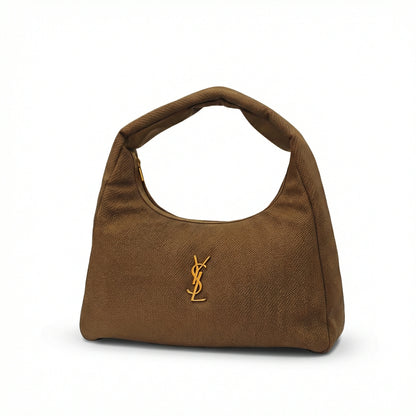 Eclipse — A curved shoulder bag with a textured finish and small metal detail.