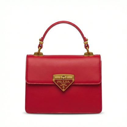 Pearl — A structured top-handle bag with a flap and front metal detail.