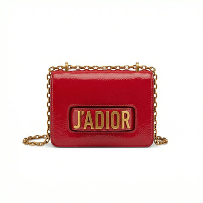 Quartz — A compact flap-style crossbody bag with a chain strap and metal accent.
