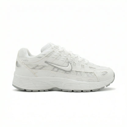 ATLAS. — A lace-up sneaker with layered panels and a raised sole.