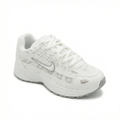 ATLAS. — A lace-up sneaker with layered panels and a raised sole.