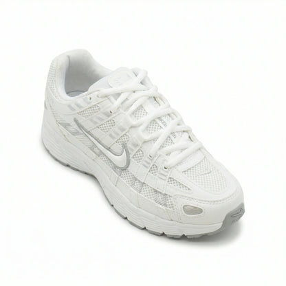 ATLAS. — A lace-up sneaker with layered panels and a raised sole.