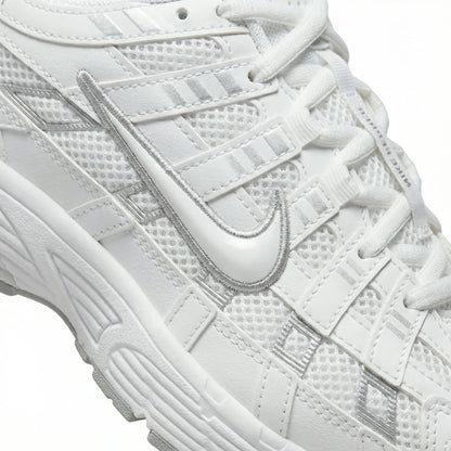 ATLAS. — A lace-up sneaker with layered panels and a raised sole.